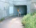 Bicyclist exiting tunnel