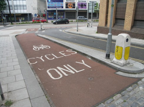 Barrier-separated bikeway with colored pavement, Bristol, England. Photo by James Mackay