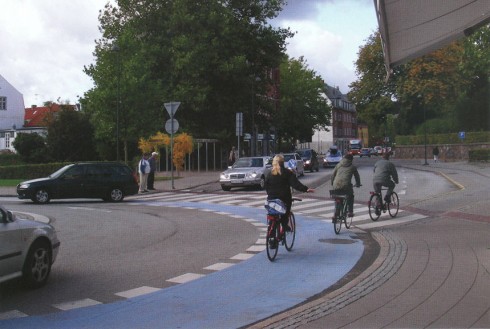 Roundabout, Lyngby, Denmark, with blue-painted bike lane. Photo by Ryan Snyder from 2011 Association of Bicycle and Pedestrian Professionals calendar