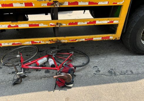Bicycle on its side with wheels under truck