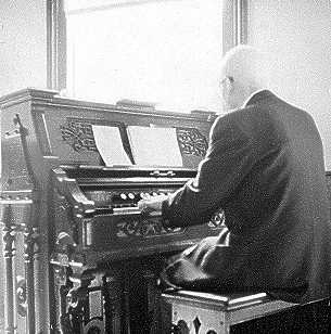 G. D. Atkinson playing the reed organ